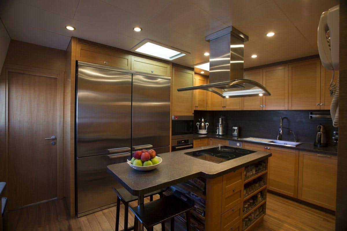 a kitchen with a stainless steel refrigerator aboard PANFELISS Yacht for Charter