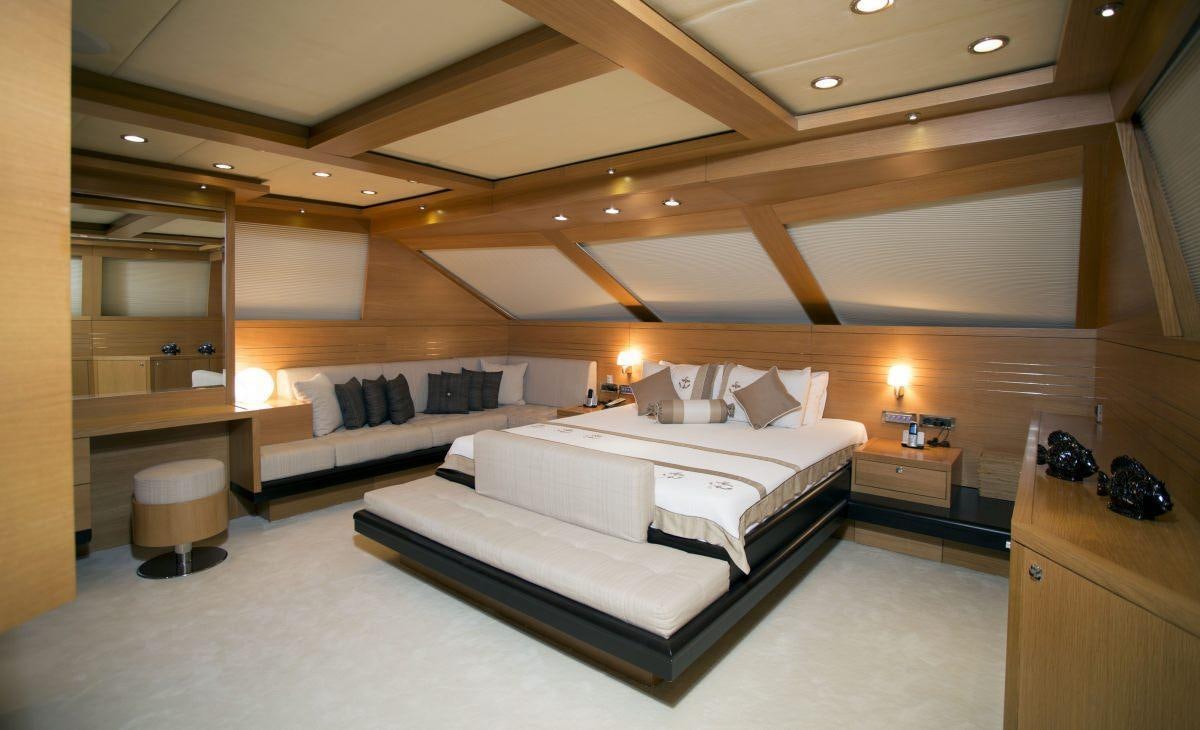 a room with a bed and a couch aboard PANFELISS Yacht for Charter