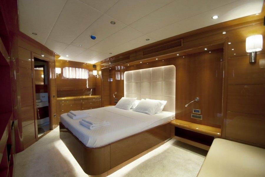 a room with a bed and a desk aboard GULMARIA Yacht for Charter