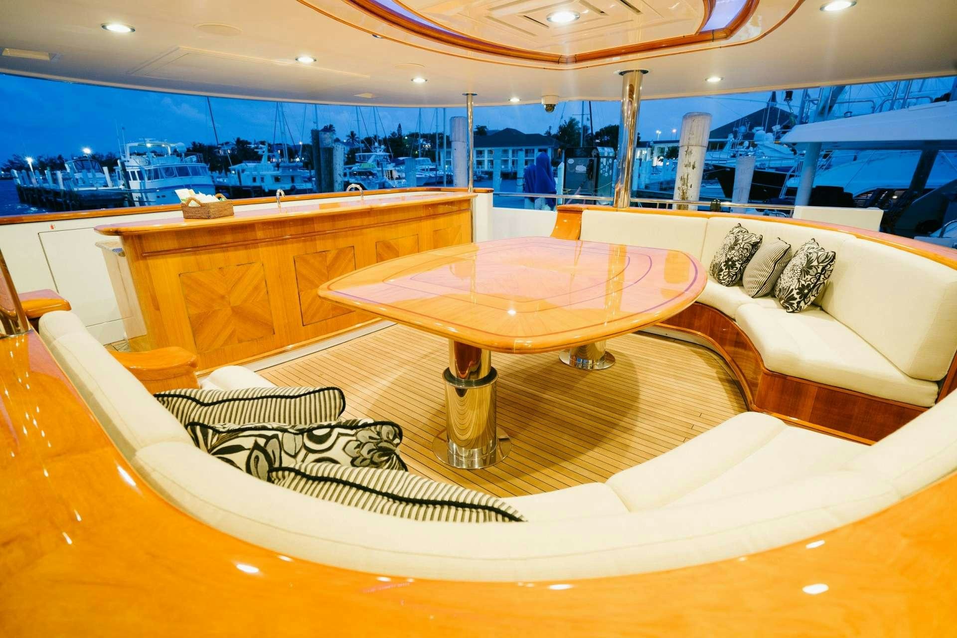 a room with a table and couches aboard EXCELLENCE Yacht for Charter
