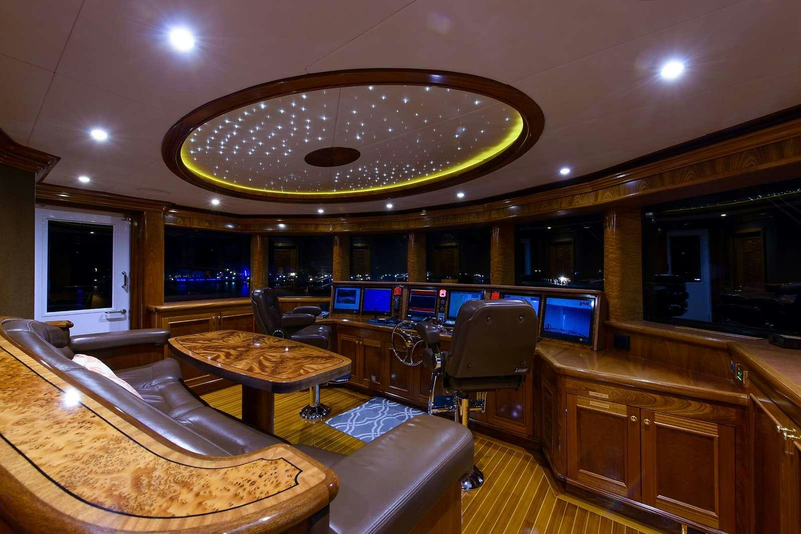 a large room with a chandelier and a table aboard EXCELLENCE Yacht for Charter