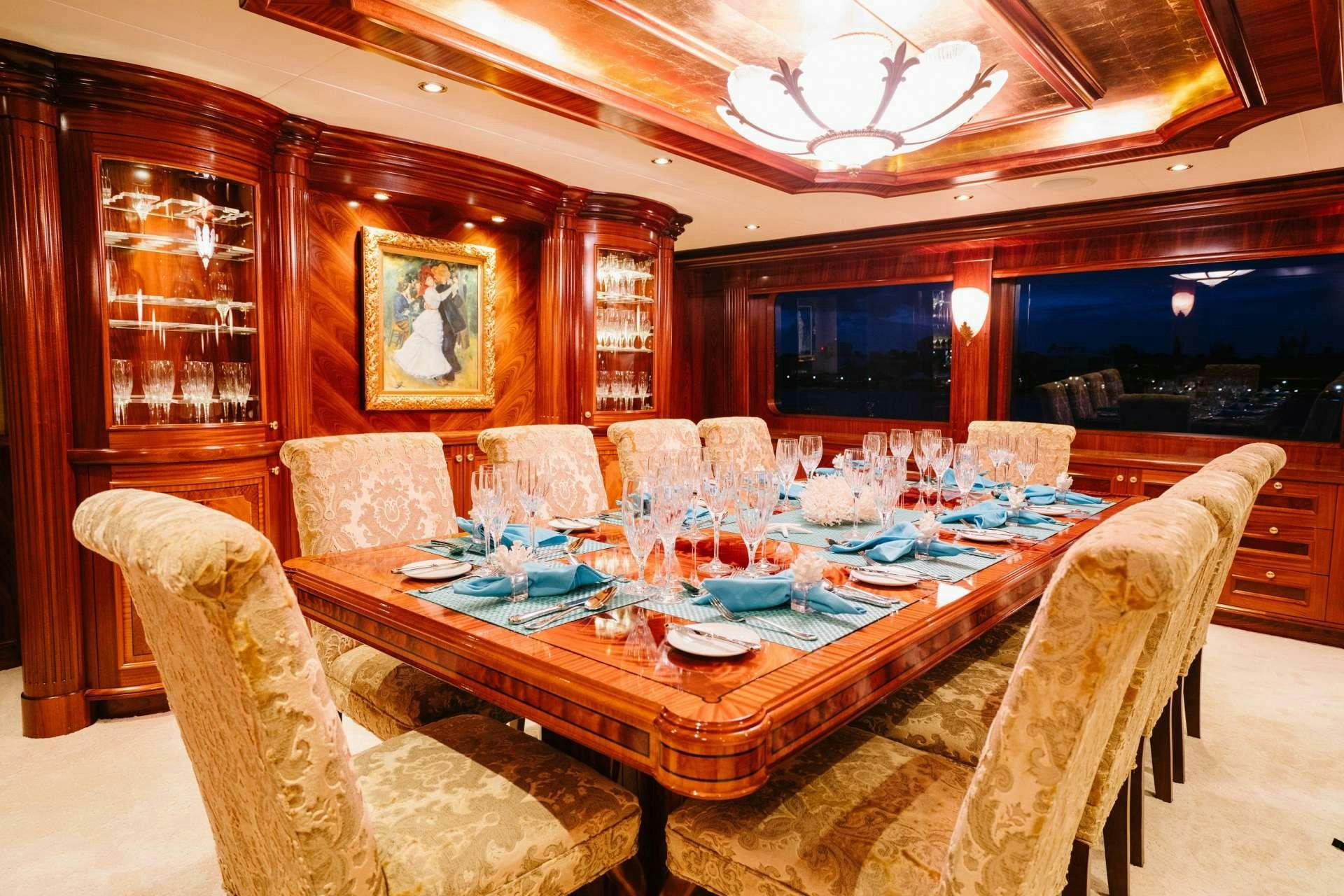 a dining room with a table set aboard EXCELLENCE Yacht for Charter