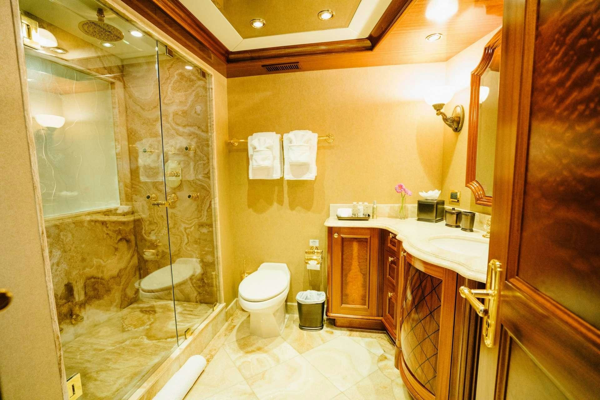 a bathroom with a glass shower aboard EXCELLENCE Yacht for Charter