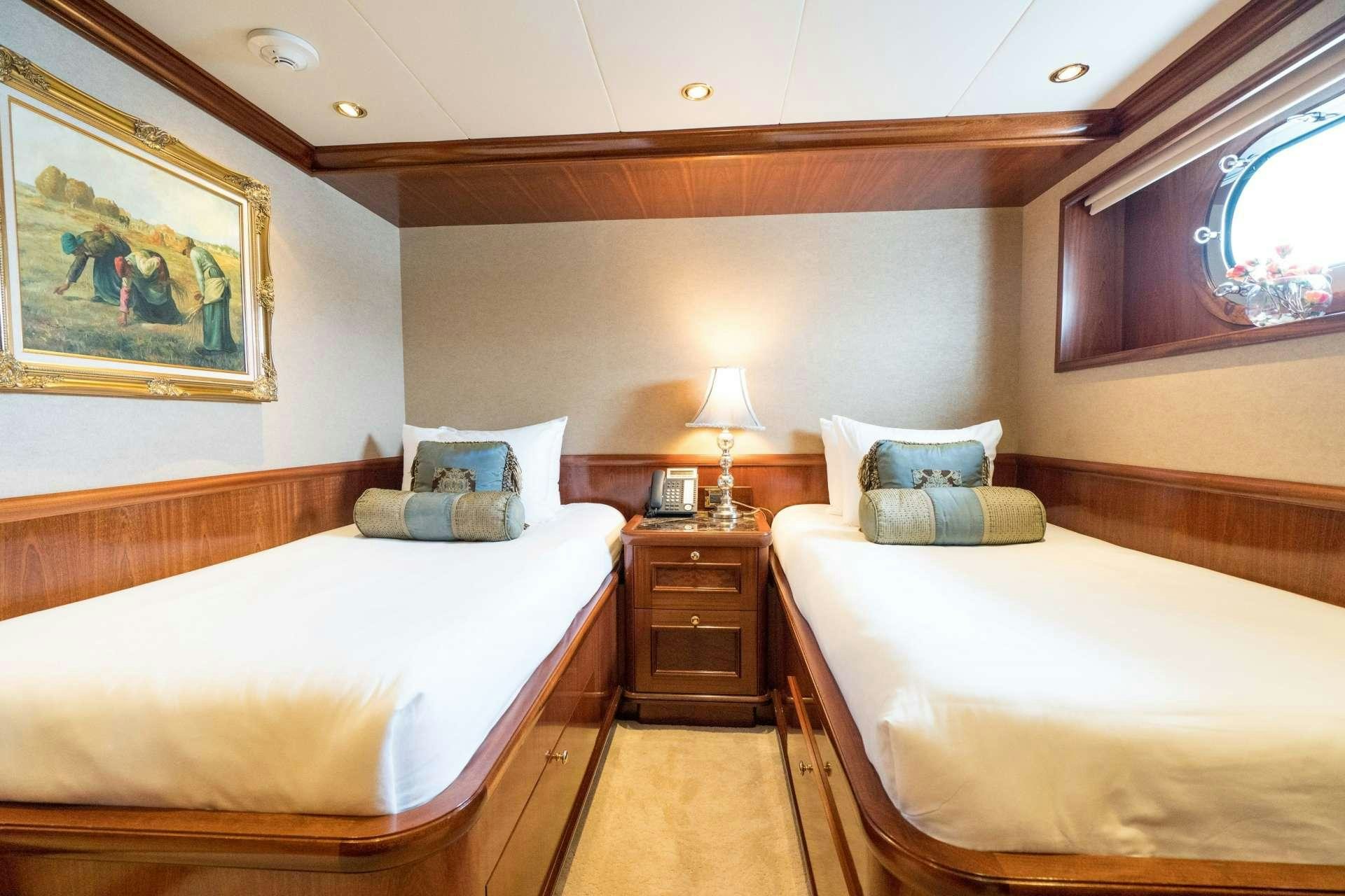 a room with two beds aboard EXCELLENCE Yacht for Charter