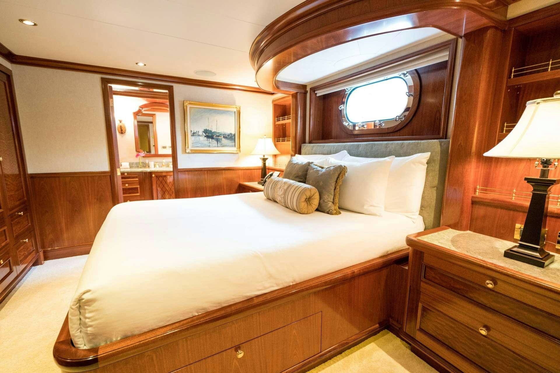 a bed in a hotel room aboard EXCELLENCE Yacht for Charter