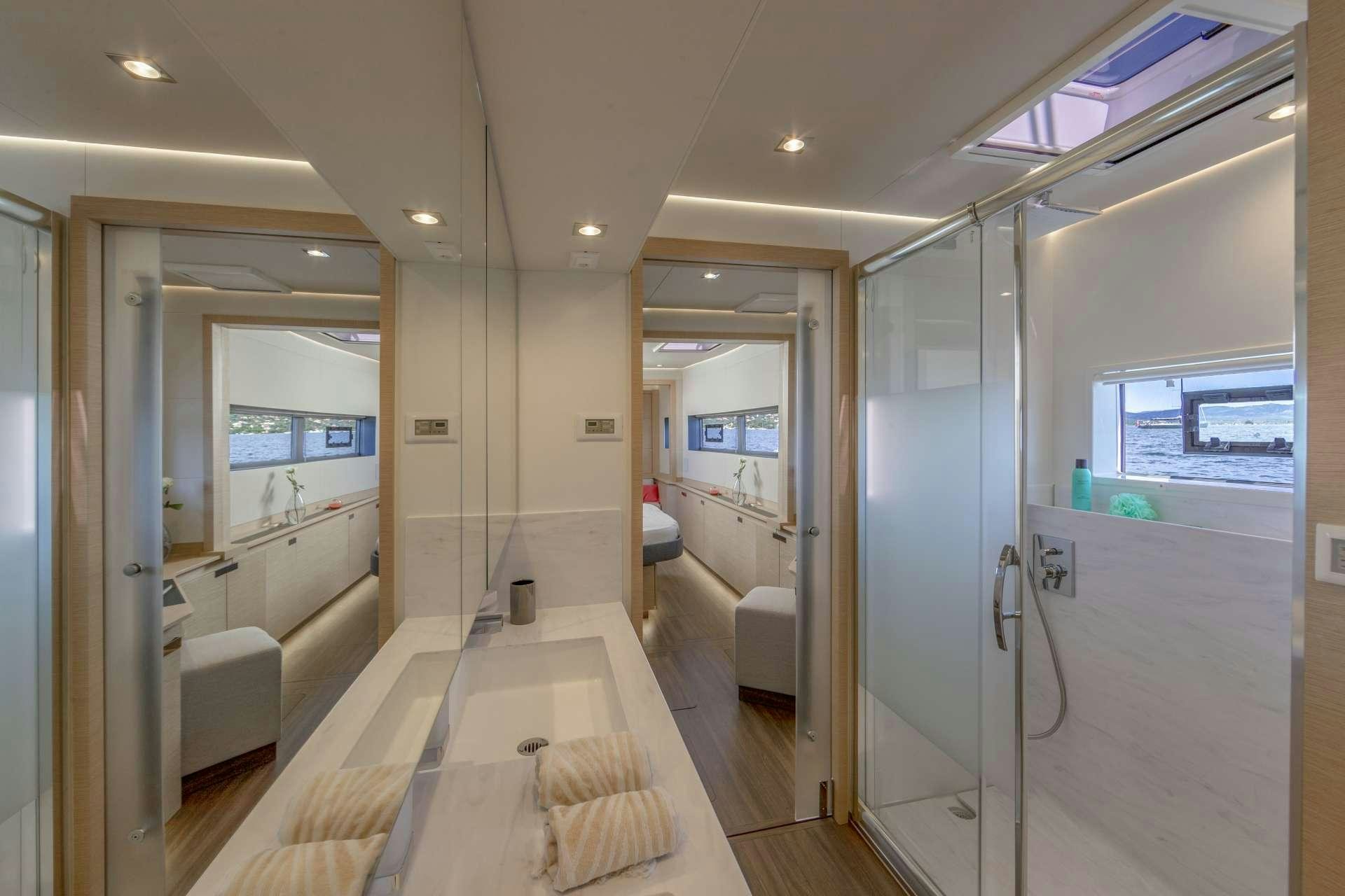a long hallway with glass doors aboard SERENISSIMA Yacht for Charter
