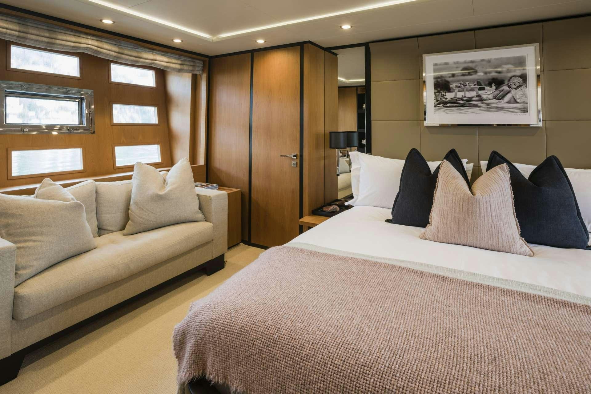 a hotel room with a bed and a couch aboard MOHASUWEI Yacht for Charter