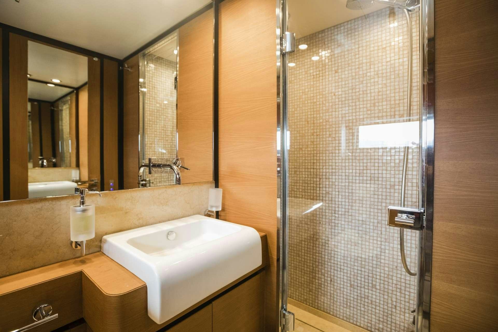 a bathroom with a sink and shower aboard MOHASUWEI Yacht for Charter