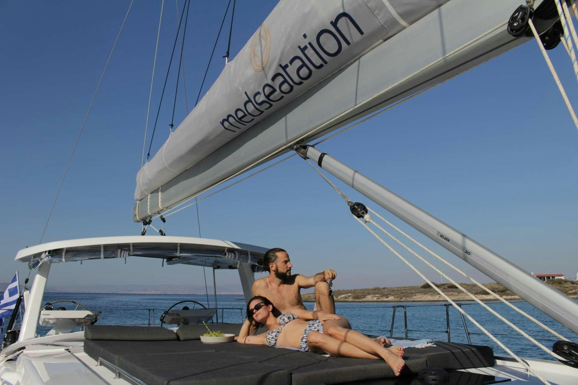 a couple of men sitting on a boat aboard MED SEA TATION Yacht for Charter