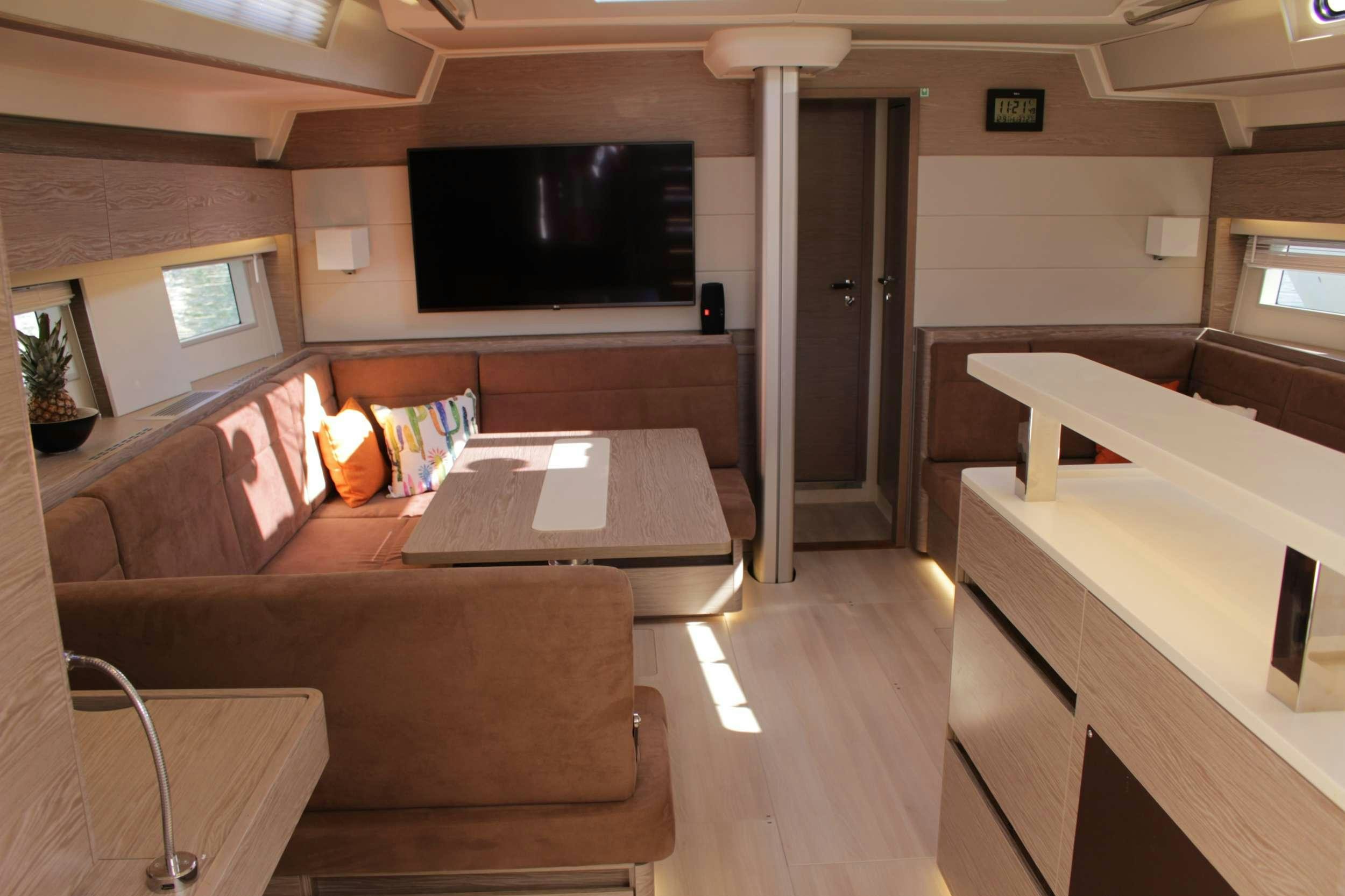 a living room with a couch and a tv aboard MED SEA TATION Yacht for Charter