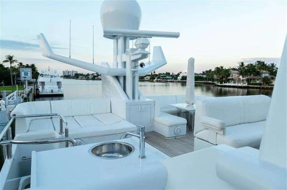 a large white building with a white roof and a white table and chairs aboard HIGH LINE Yacht for Charter