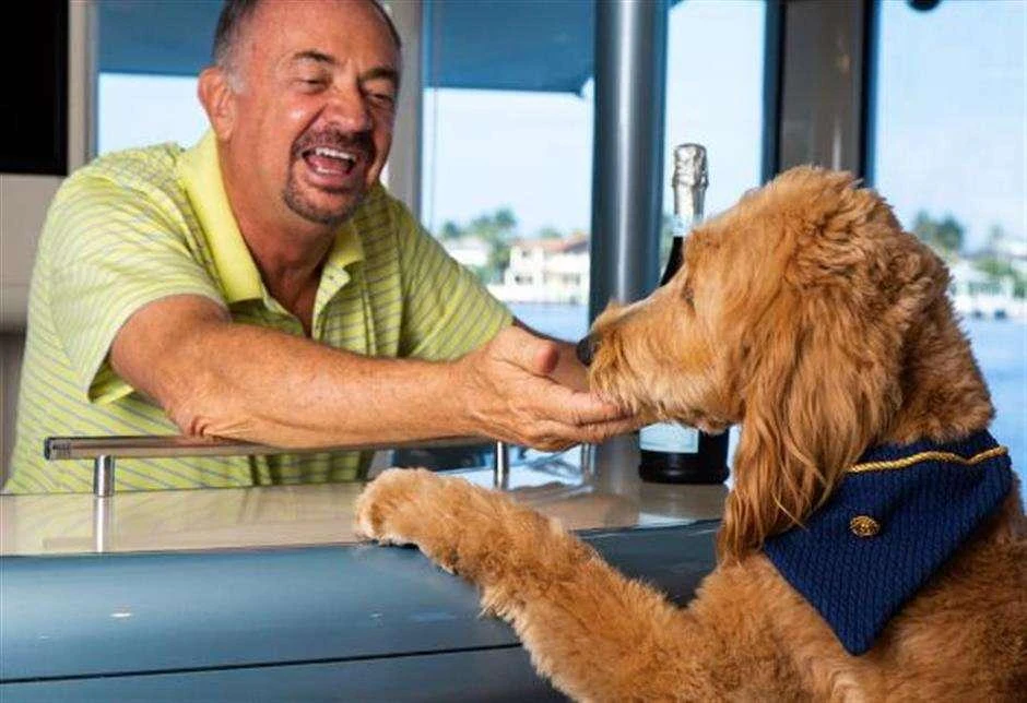 a man with a dog aboard HIGH LINE Yacht for Charter