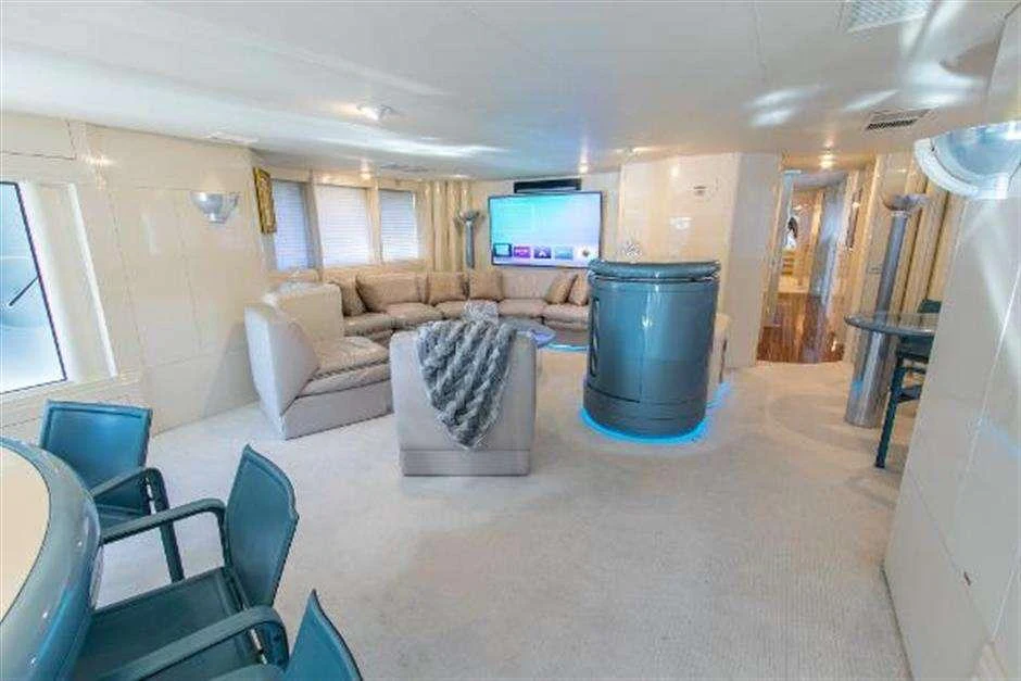 a living room with a large blue tub aboard HIGH LINE Yacht for Charter