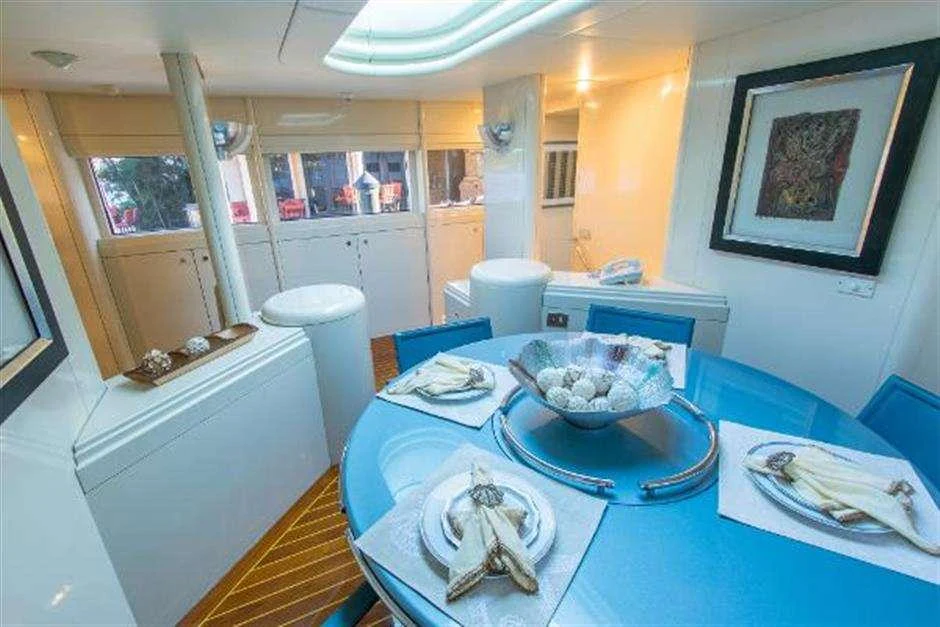 a kitchen with a blue table cloth aboard HIGH LINE Yacht for Charter