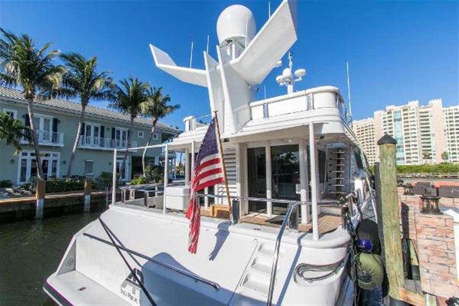 a boat with a flag on the front aboard HIGH LINE Yacht for Charter