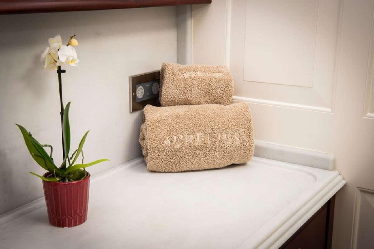 a couple of flowers in a vase on a table aboard AURELIUS 111 Yacht for Charter