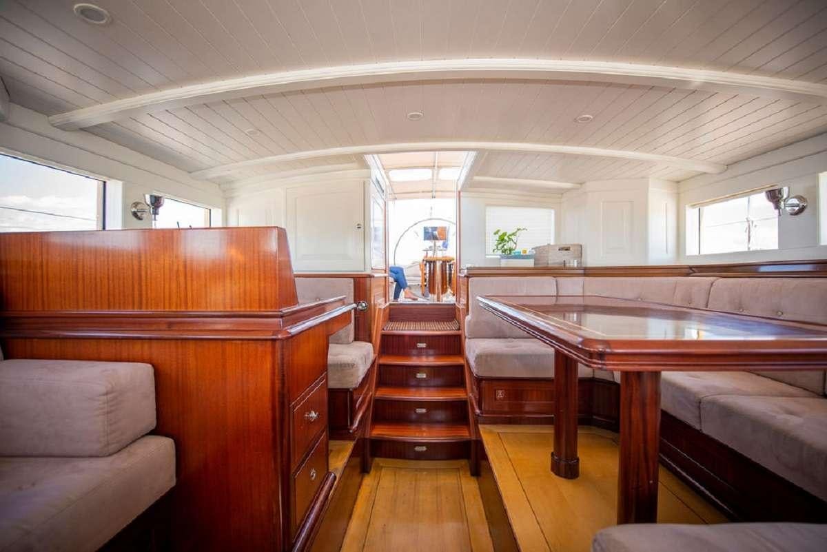 a room with a table and chairs aboard AURELIUS 111 Yacht for Charter