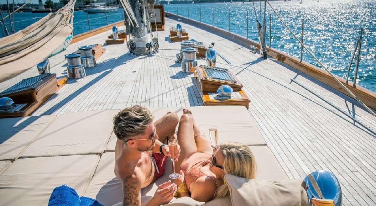 a group of people on a deck aboard AURELIUS 111 Yacht for Charter