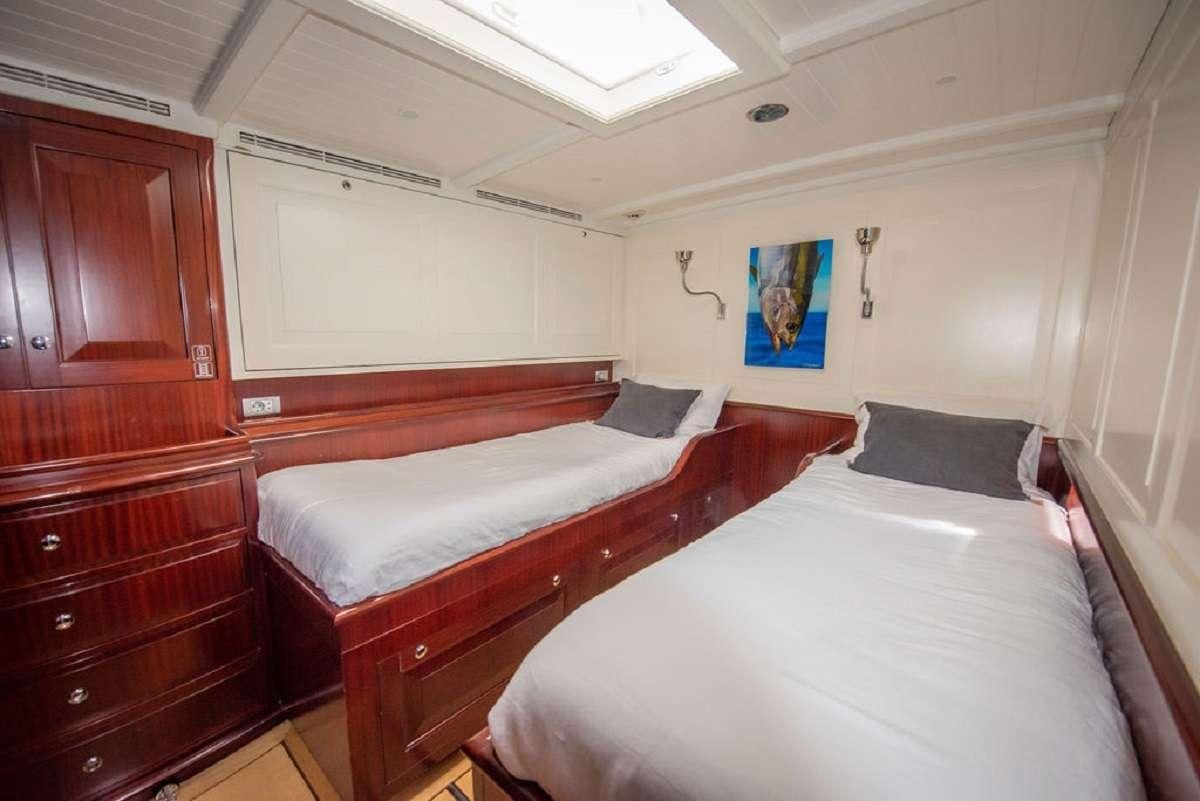 a couple of beds in a room aboard AURELIUS 111 Yacht for Charter