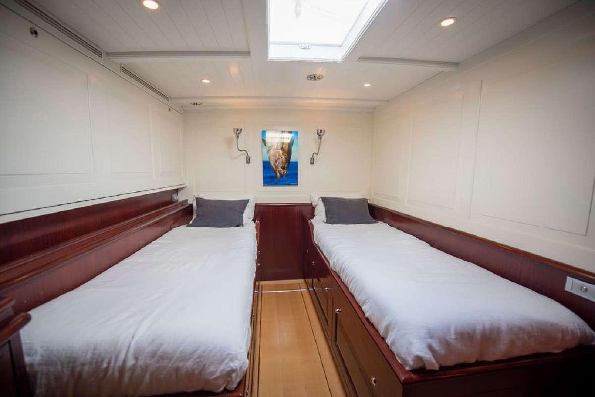 a room with two beds aboard AURELIUS 111 Yacht for Charter