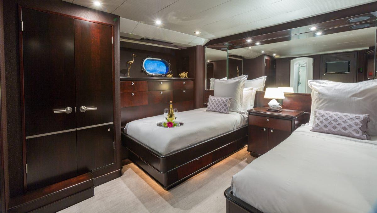 a room with a bed and a desk aboard UNBRIDLED Yacht for Charter