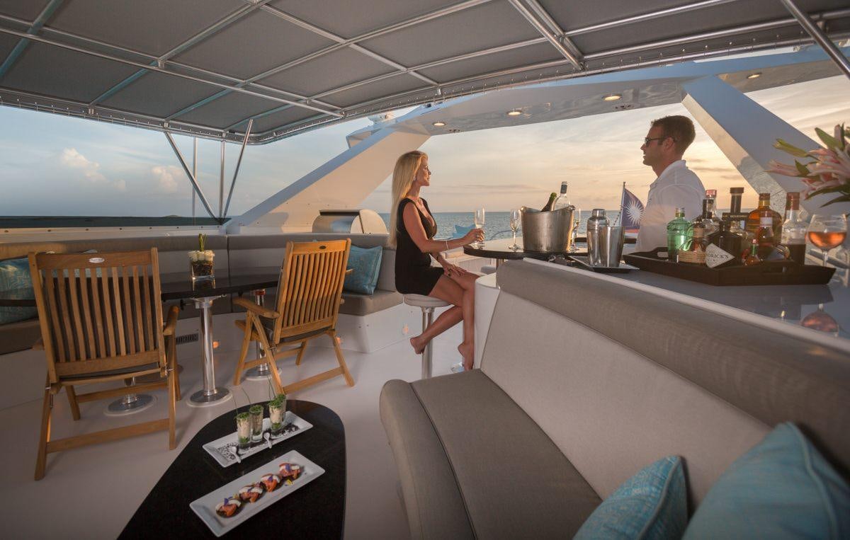 a man and woman in a restaurant aboard UNBRIDLED Yacht for Charter