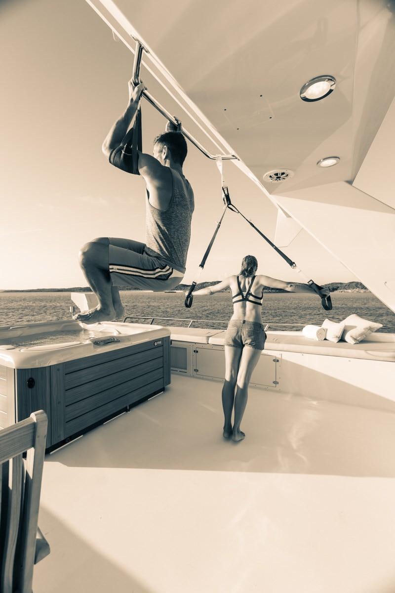 a person jumping on a staircase aboard UNBRIDLED Yacht for Charter