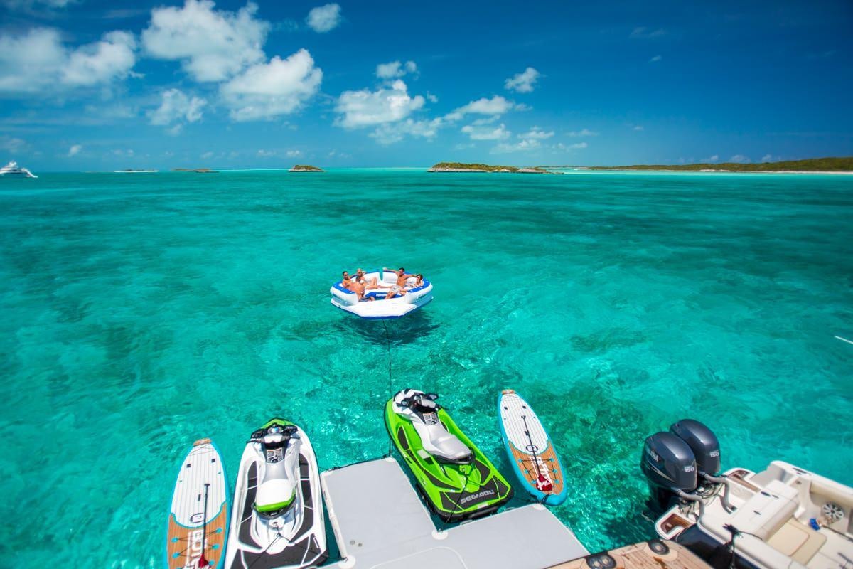 a group of boats on a body of water aboard UNBRIDLED Yacht for Charter