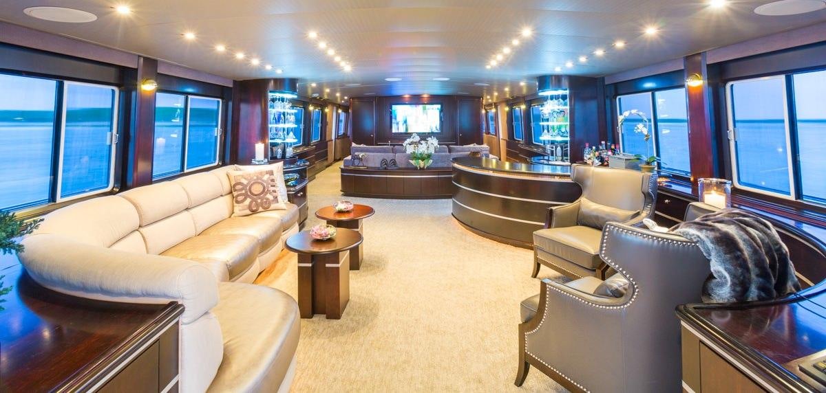a living room with a large window aboard UNBRIDLED Yacht for Charter