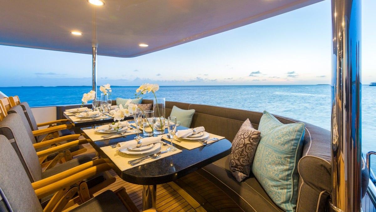 a table with a flower on it aboard UNBRIDLED Yacht for Charter
