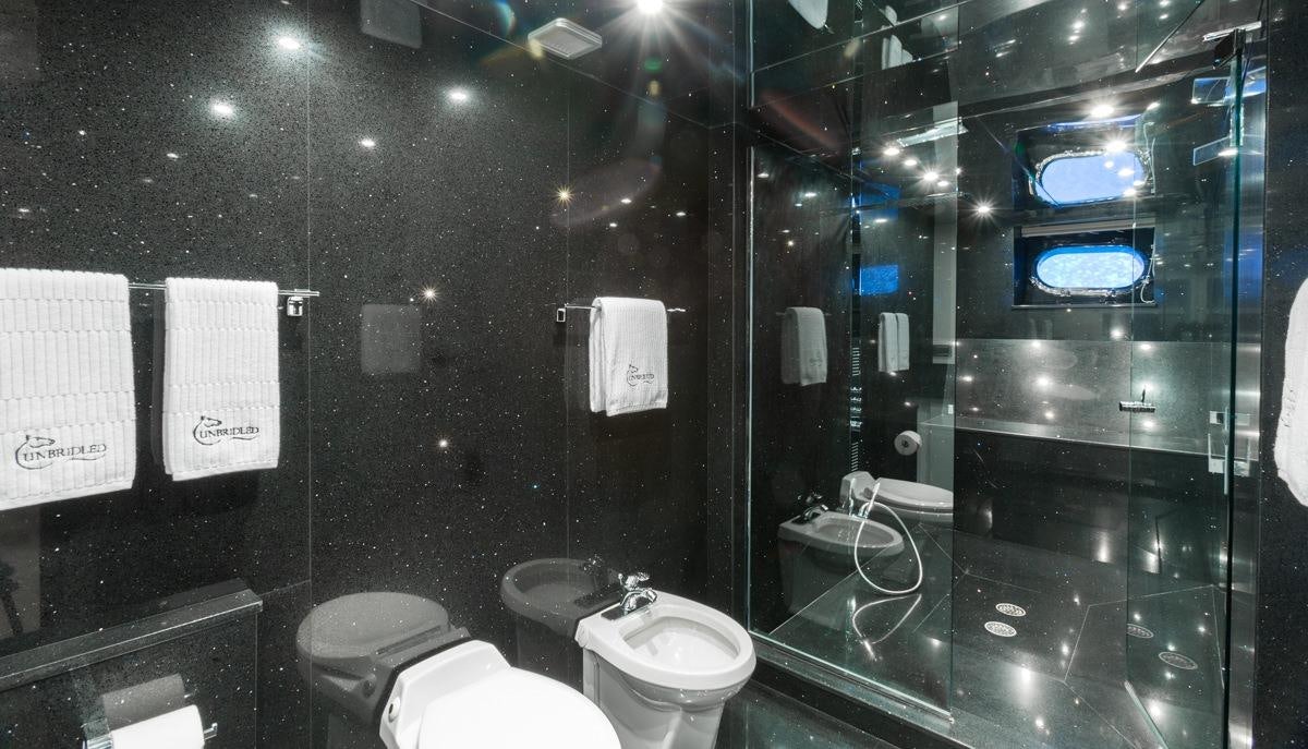 a bathroom with a glass wall aboard UNBRIDLED Yacht for Charter