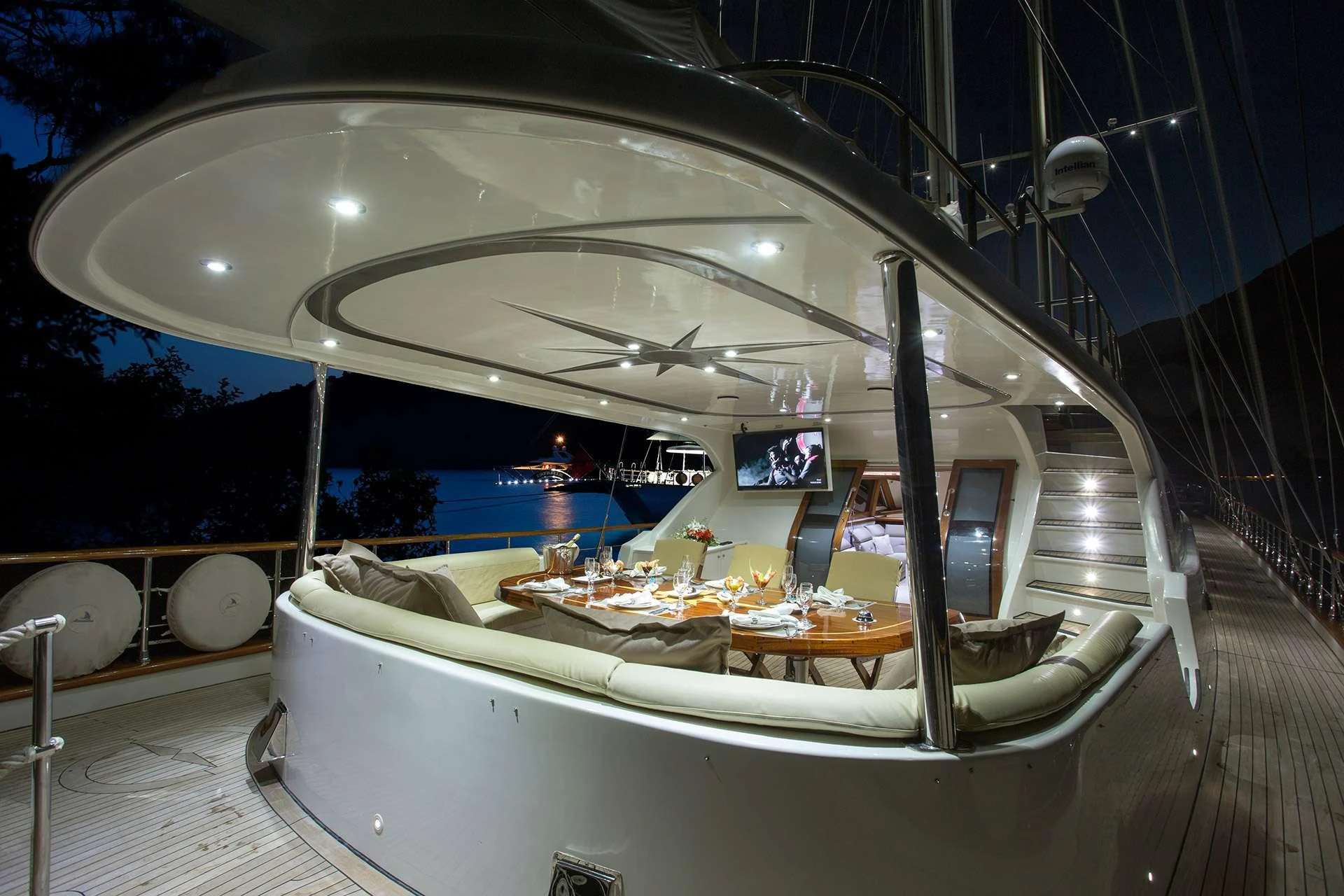 a room with a large bed and a table with food on it aboard ALESSANDRO I Yacht for Charter