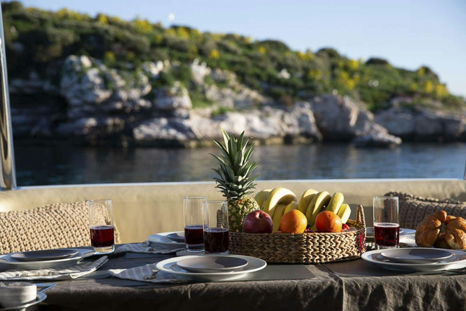 a table with food and drinks on it aboard MEDUSA Yacht for Charter