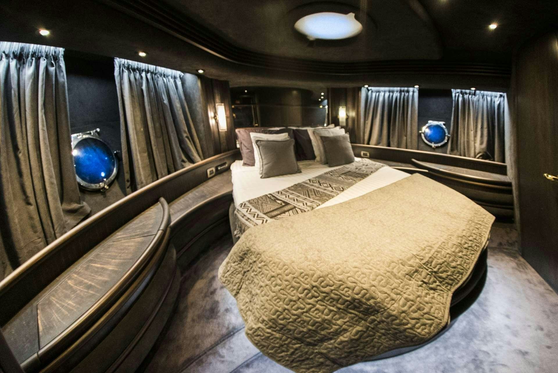 a room with a bed and a mirror aboard MEDUSA Yacht for Charter