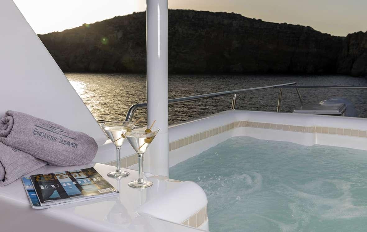 a book and wine glass on a boat aboard ENDLESS SUMMER Yacht for Charter