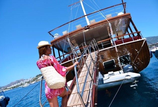 a person standing next to a boat aboard LOVE BOAT Yacht for Charter