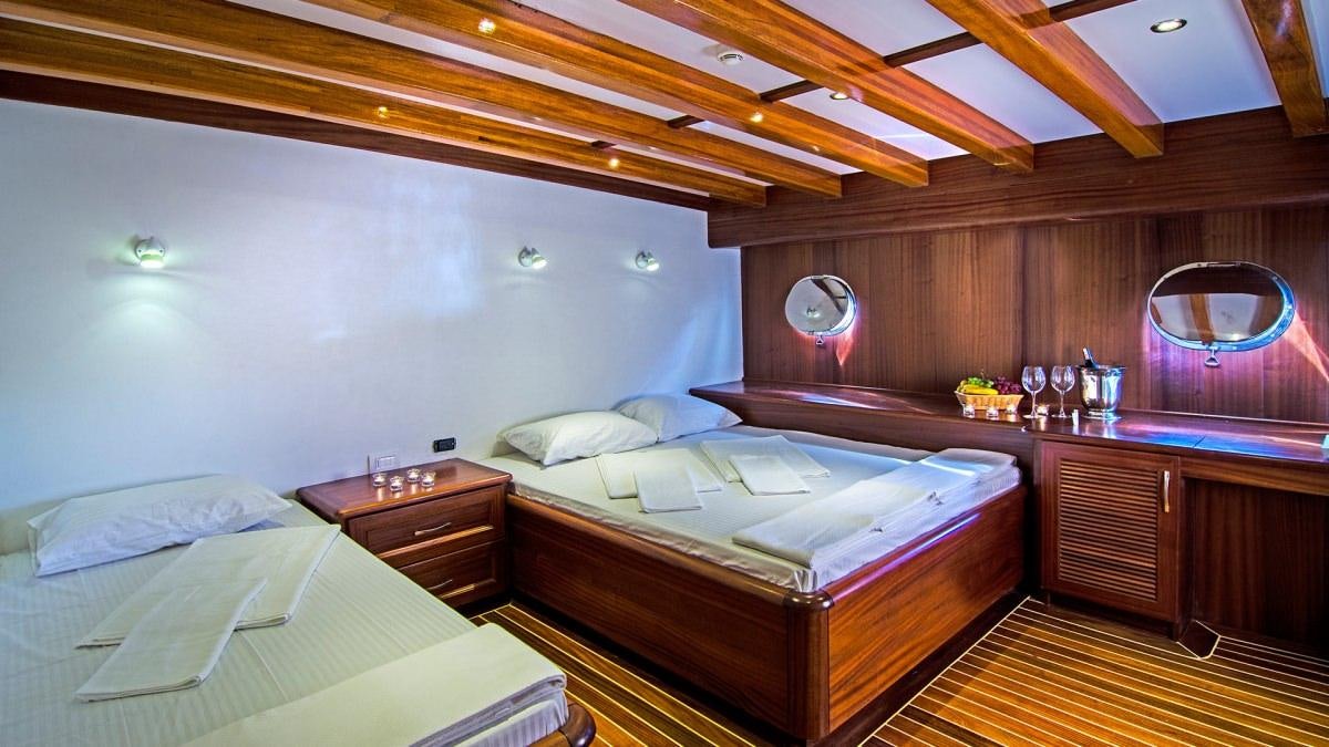 a room with two beds aboard LOVE BOAT Yacht for Charter