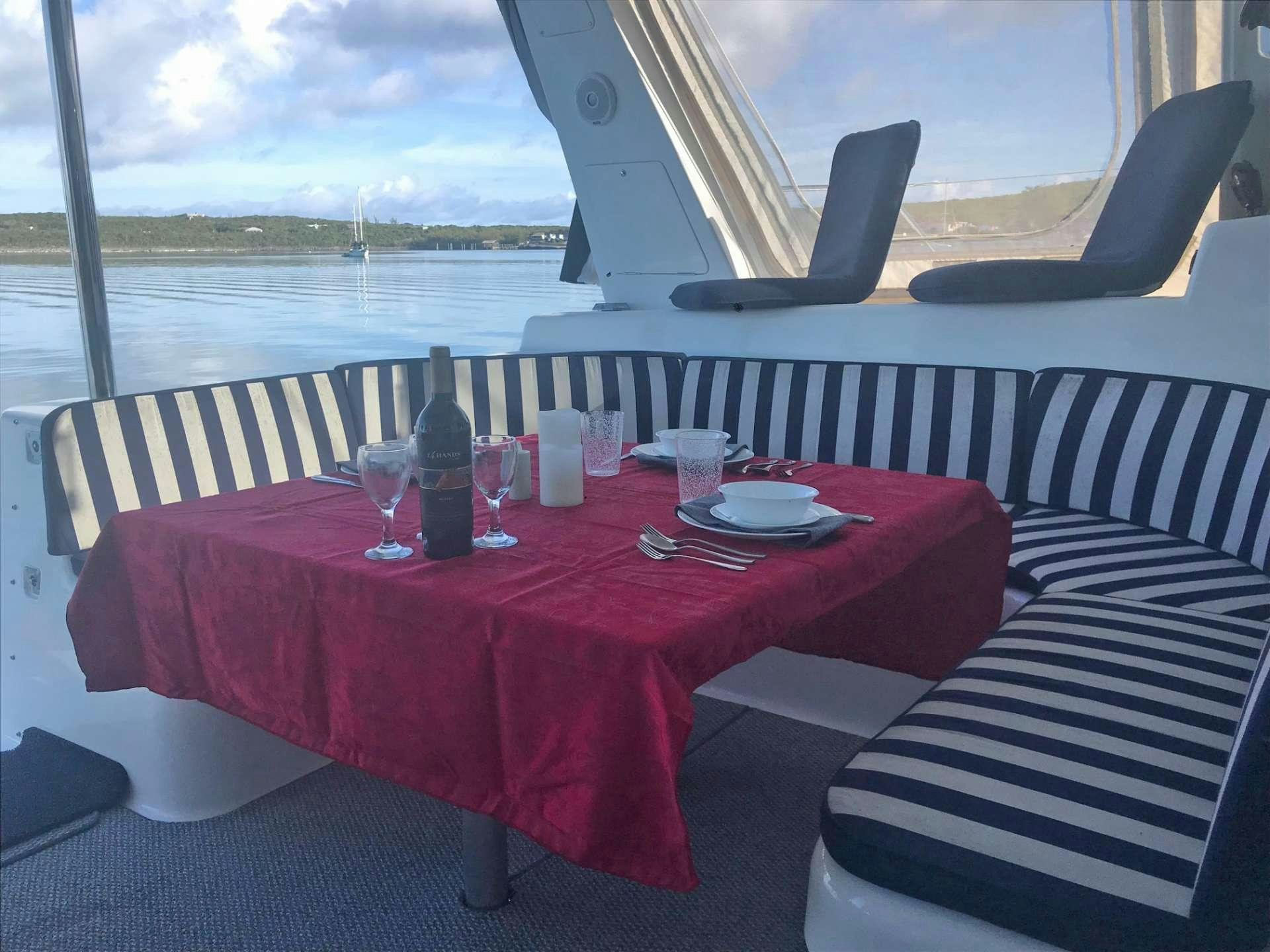 a table with wine glasses on it aboard GUINEVERE Yacht for Charter