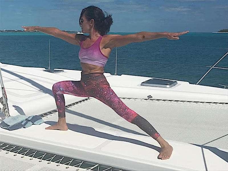 a woman jumping on a boat aboard GUINEVERE Yacht for Charter