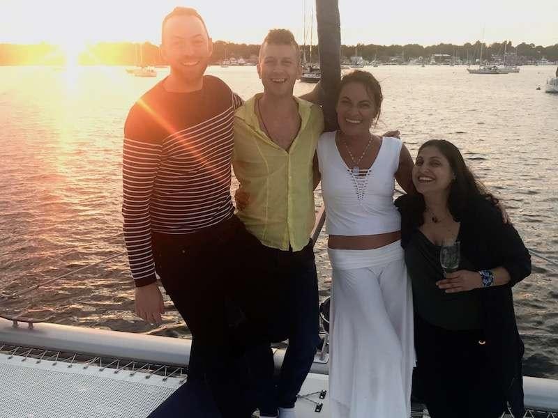 a group of people posing for a photo on a boat aboard GUINEVERE Yacht for Charter