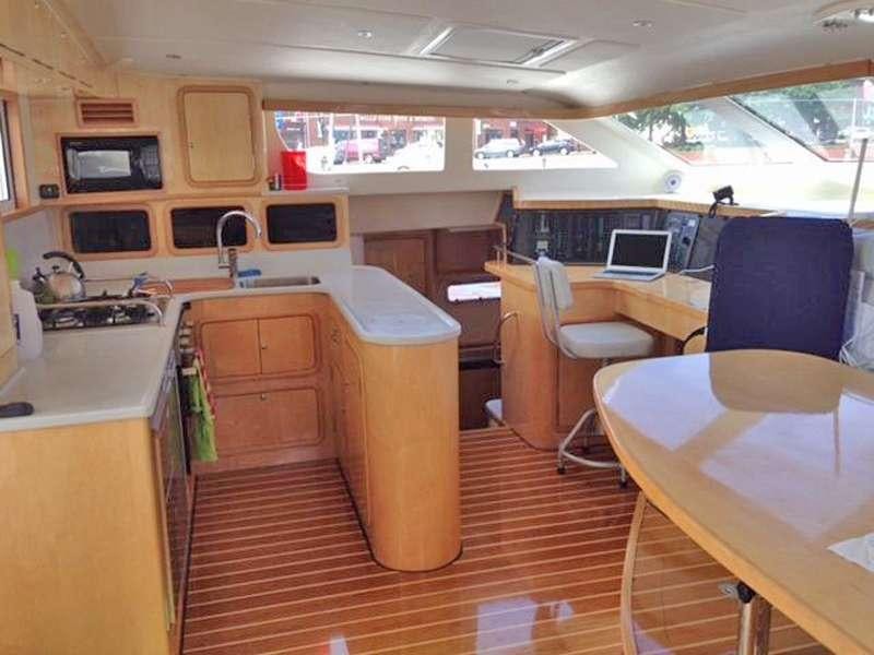 a small kitchen with a table and chairs aboard GUINEVERE Yacht for Charter