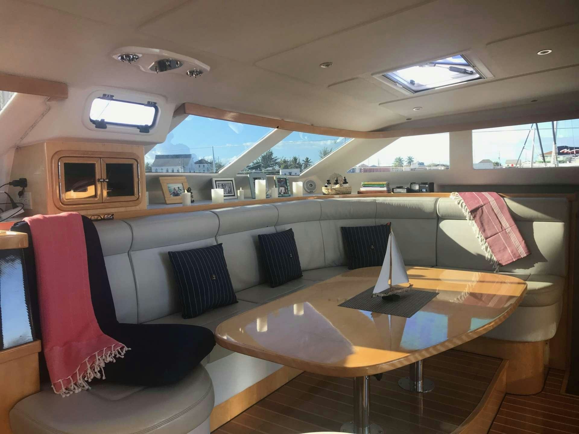 inside of a building with a table and chairs aboard GUINEVERE Yacht for Charter