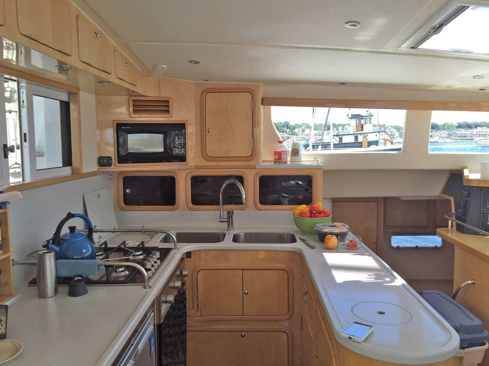 a kitchen with a microwave oven and a sink aboard GUINEVERE Yacht for Charter