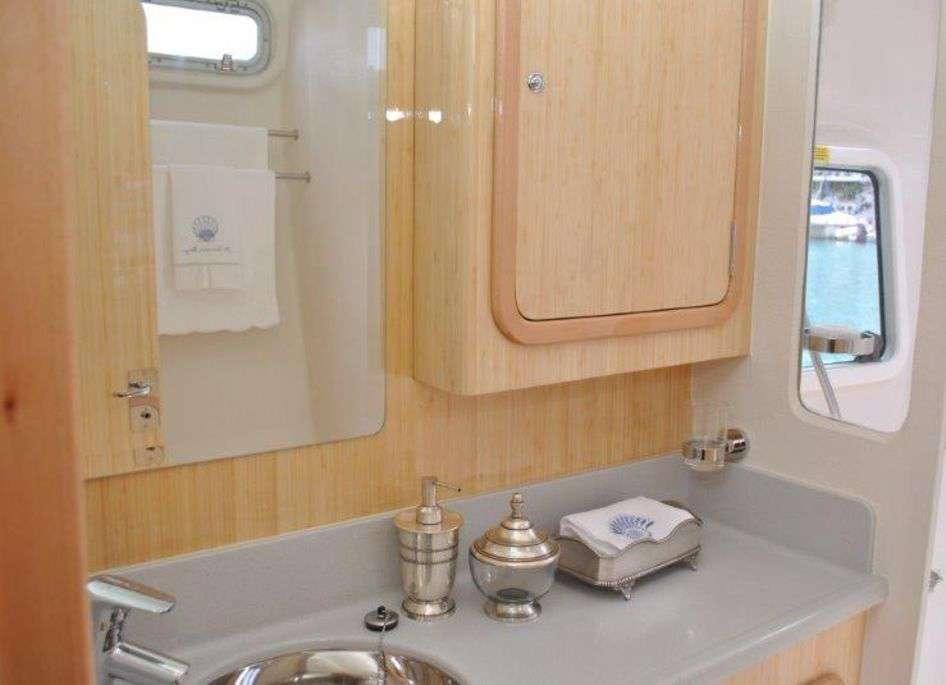 a bathroom with a sink and a mirror aboard GUINEVERE Yacht for Charter