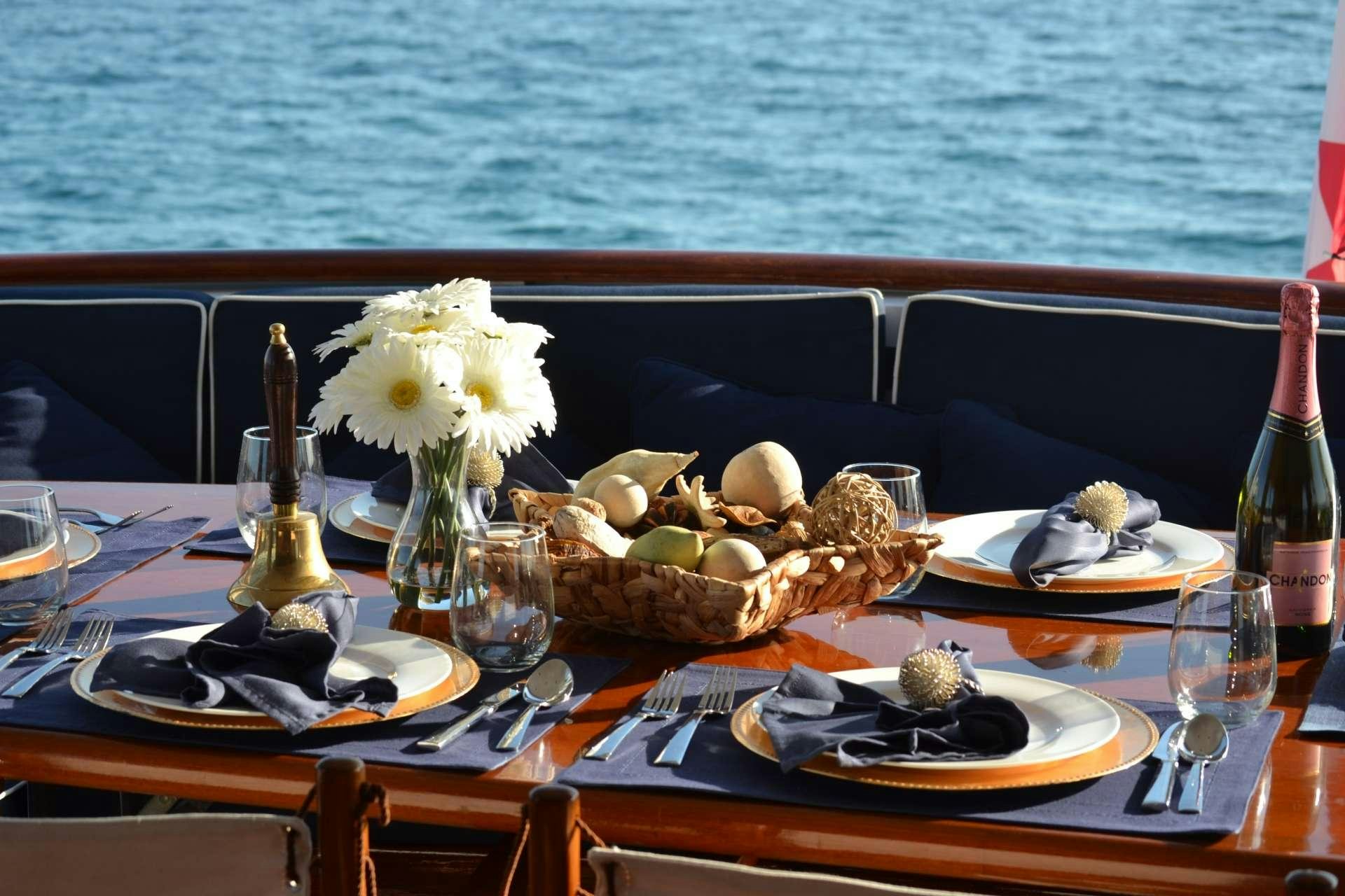 a table with food and wine aboard BONAPARTE Yacht for Charter