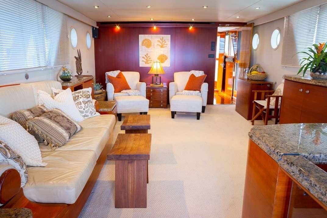 a living room with a couch and a table aboard BONAPARTE Yacht for Charter