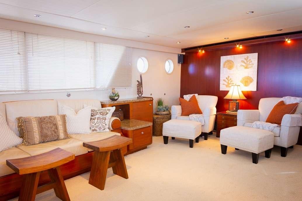 a living room with a couch and a table aboard BONAPARTE Yacht for Charter