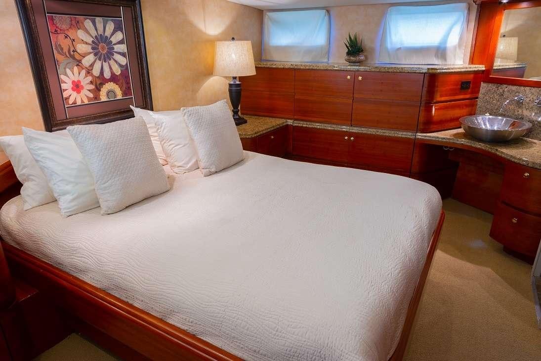 a bed with white sheets and pillows aboard BONAPARTE Yacht for Charter