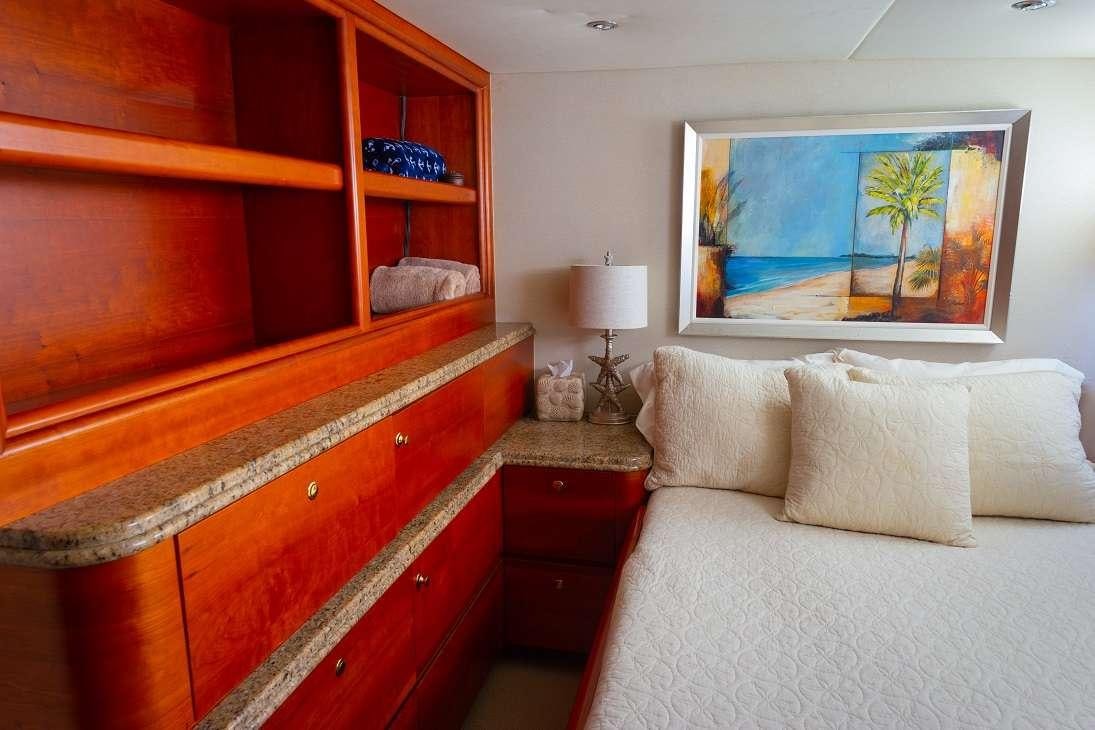 a room with a bed and a painting on the wall aboard BONAPARTE Yacht for Charter