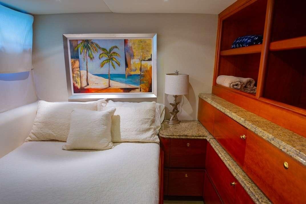 a bedroom with a bed and a painting on the wall aboard BONAPARTE Yacht for Charter